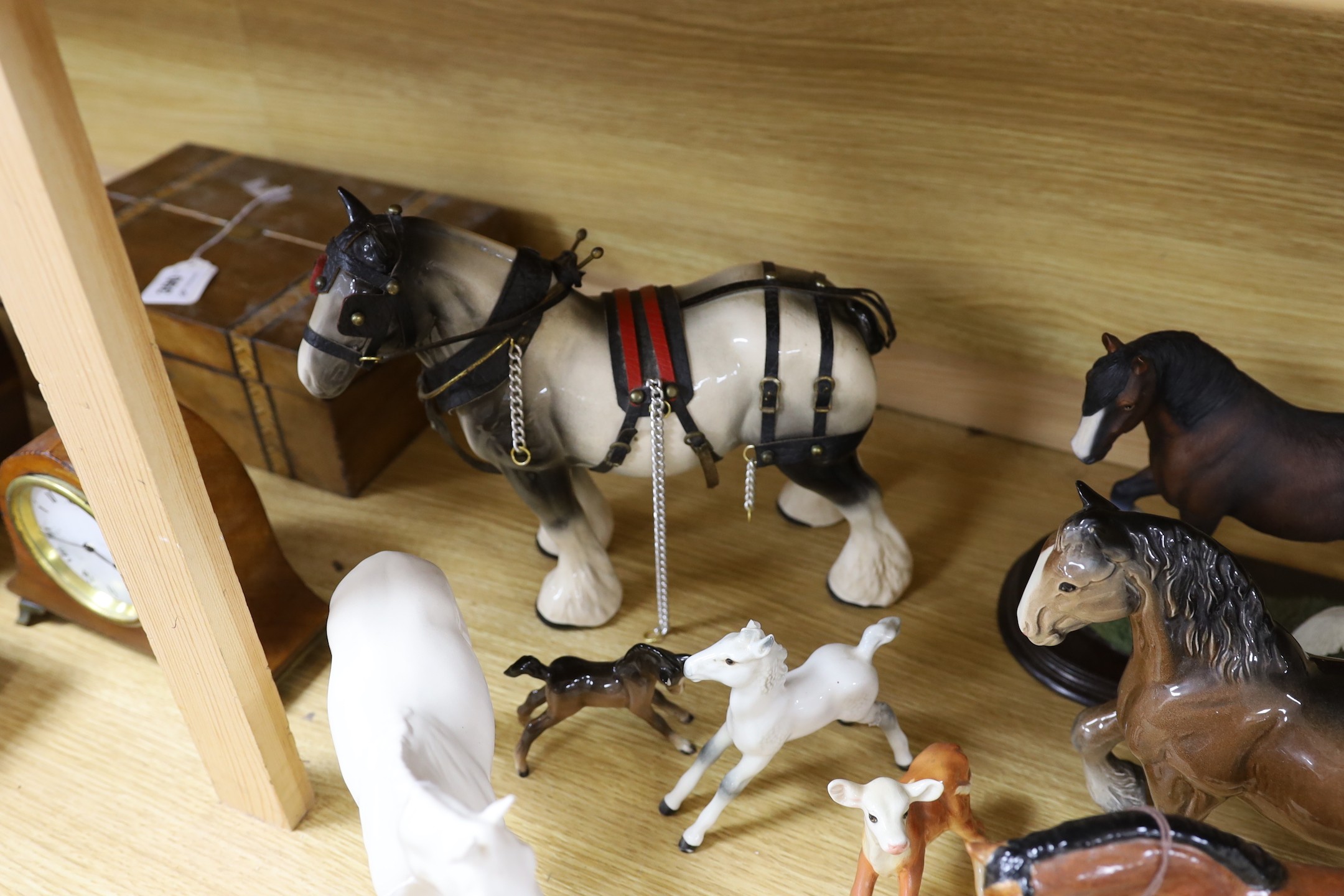 A collection of mixed Beswick, horses, to include cart horses a wall pocket, white glazed horse and a Border Fine Arts Clysdale Stallion